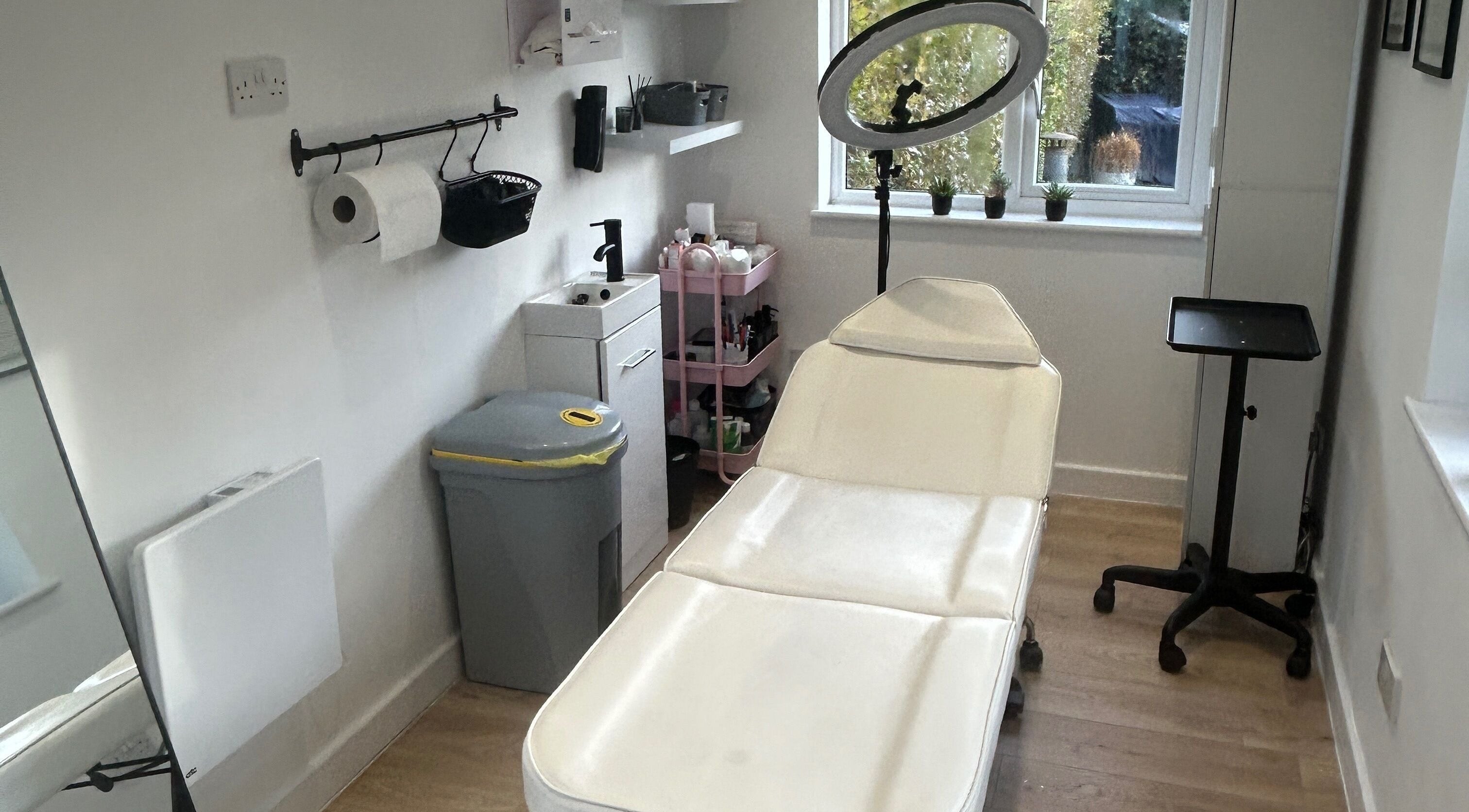 Cozy treatment room at Dayna Louise, Leeds, England, GB, featuring a modern therapy bed and natural light.