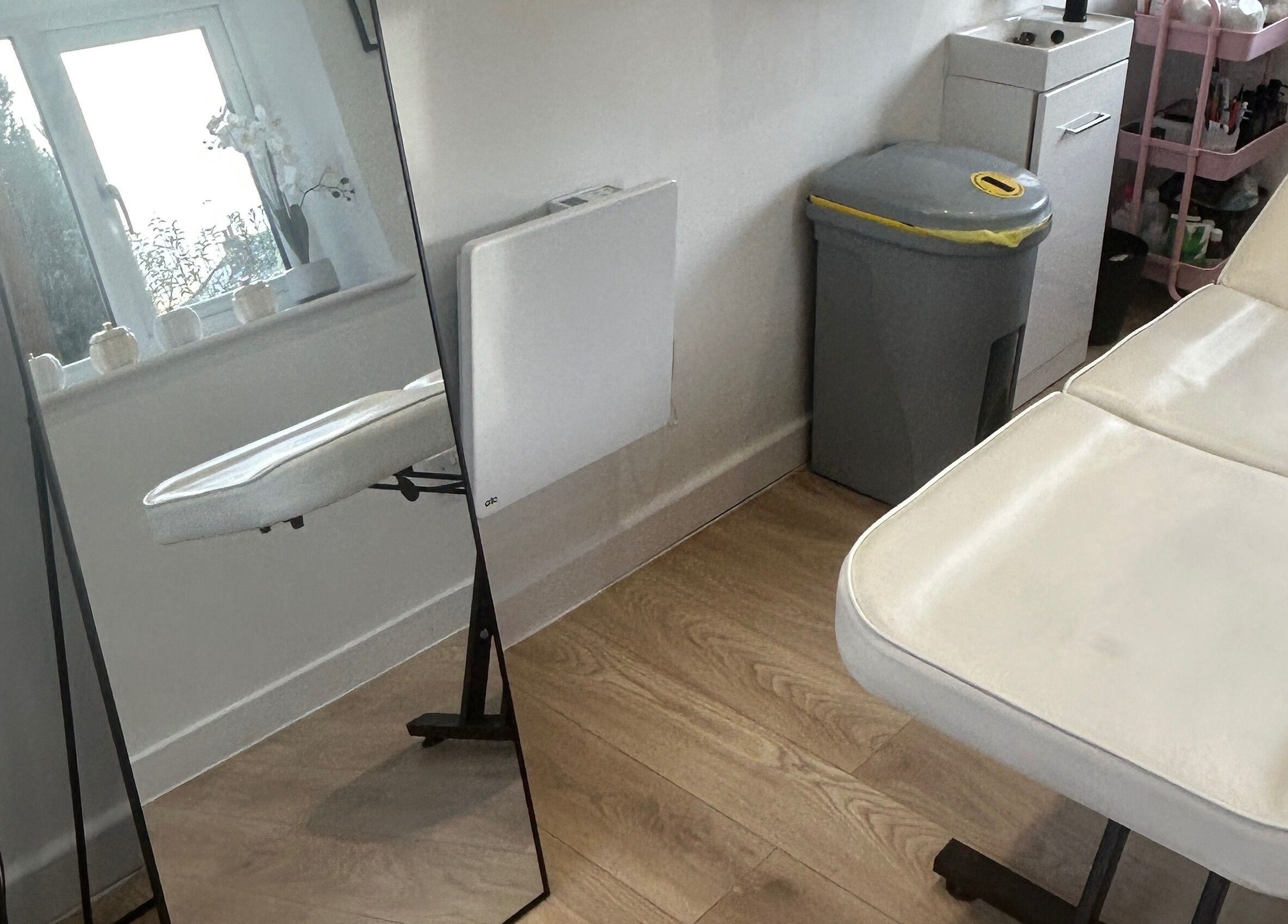 Dayna Louise beauty room in Leeds, England, GB, featuring a treatment bed and mirror for a relaxing experience.