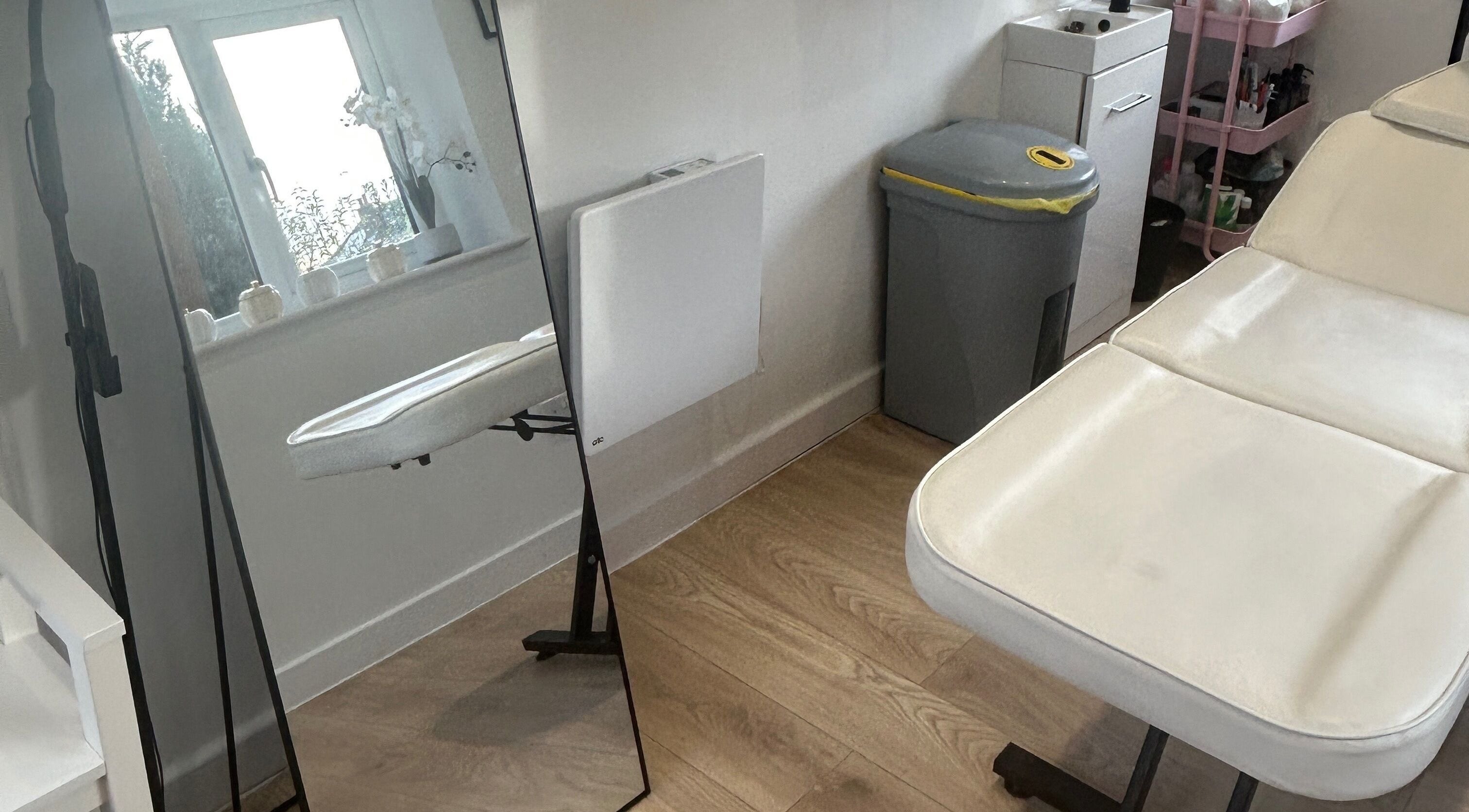 Dayna Louise beauty room in Leeds, England, GB, featuring a treatment bed and mirror for a relaxing experience.