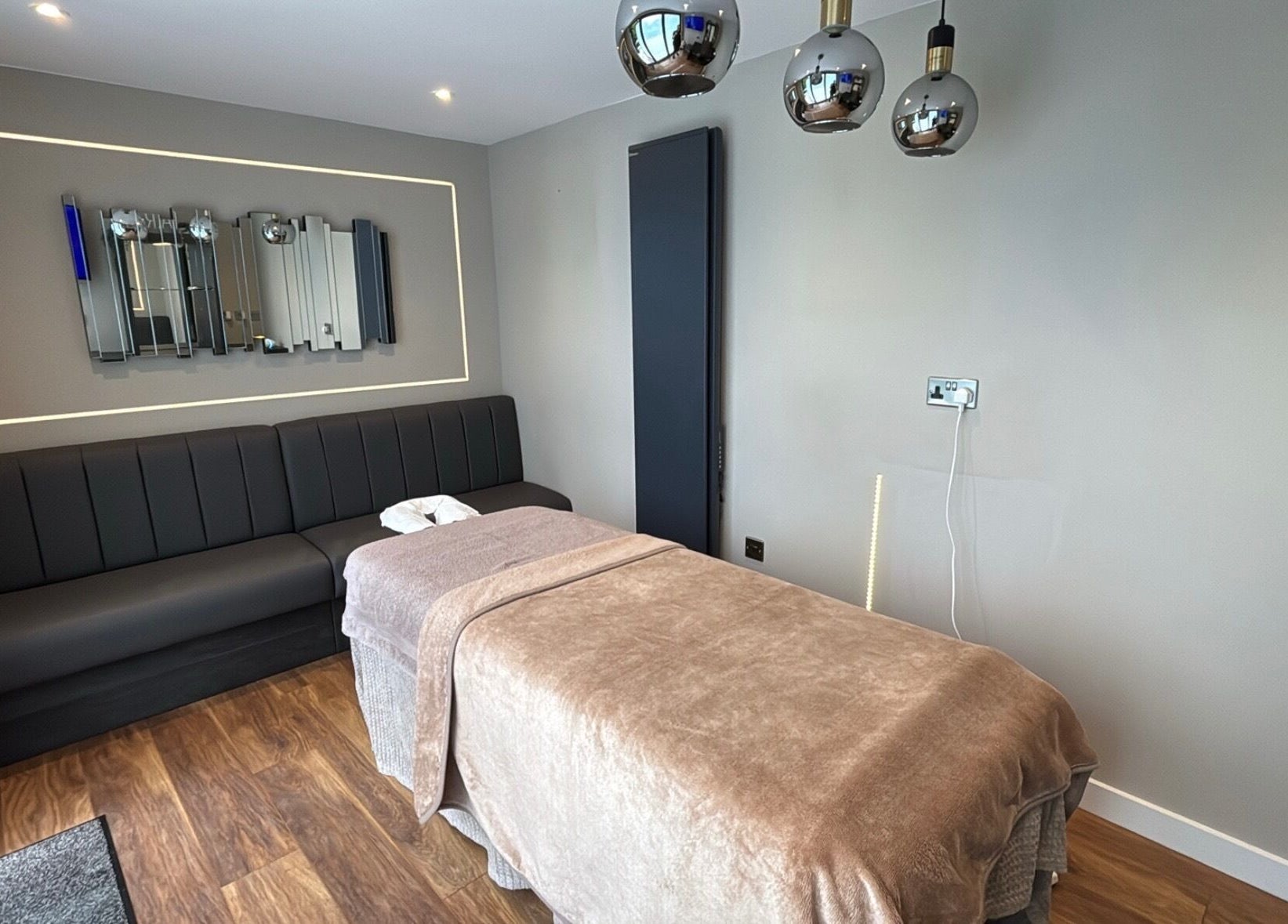 Calming massage room at Massage Therapy by Nicola in Chorley, England, GB with a cozy bed and modern decor.