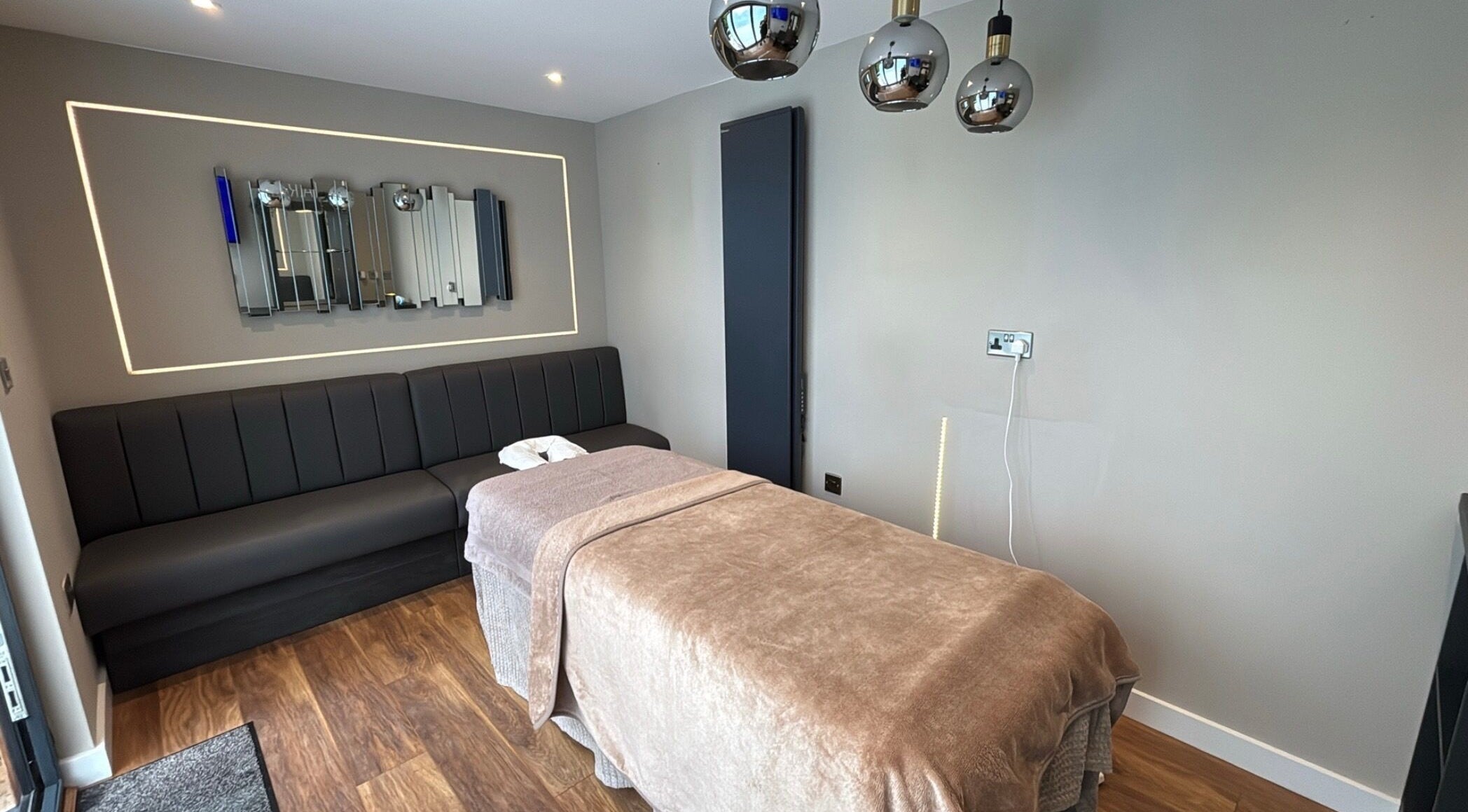 Calming massage room at Massage Therapy by Nicola in Chorley, England, GB with a cozy bed and modern decor.