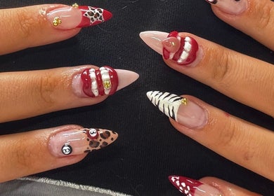 Stylish nail art at Byhollie, Rochdale, England, GB, showcasing unique designs with red and white accents.
