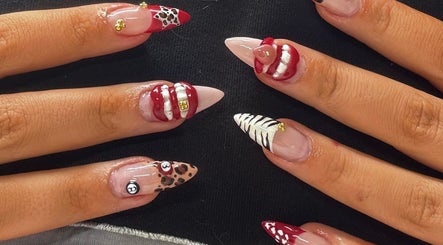 Stylish nail art at Byhollie, Rochdale, England, GB, showcasing unique designs with red and white accents.
