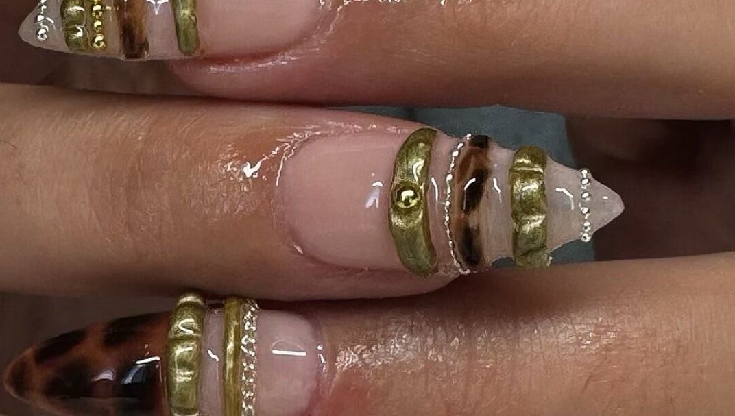 Elegant nail art with gold accents at Byhollie, Rochdale, England, GB, showcasing intricate design.