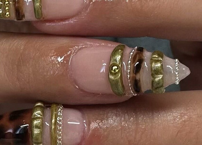 Elegant nail art with gold accents at Byhollie, Rochdale, England, GB, showcasing intricate design.
