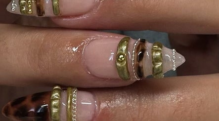 Elegant nail art with gold accents at Byhollie, Rochdale, England, GB, showcasing intricate design.