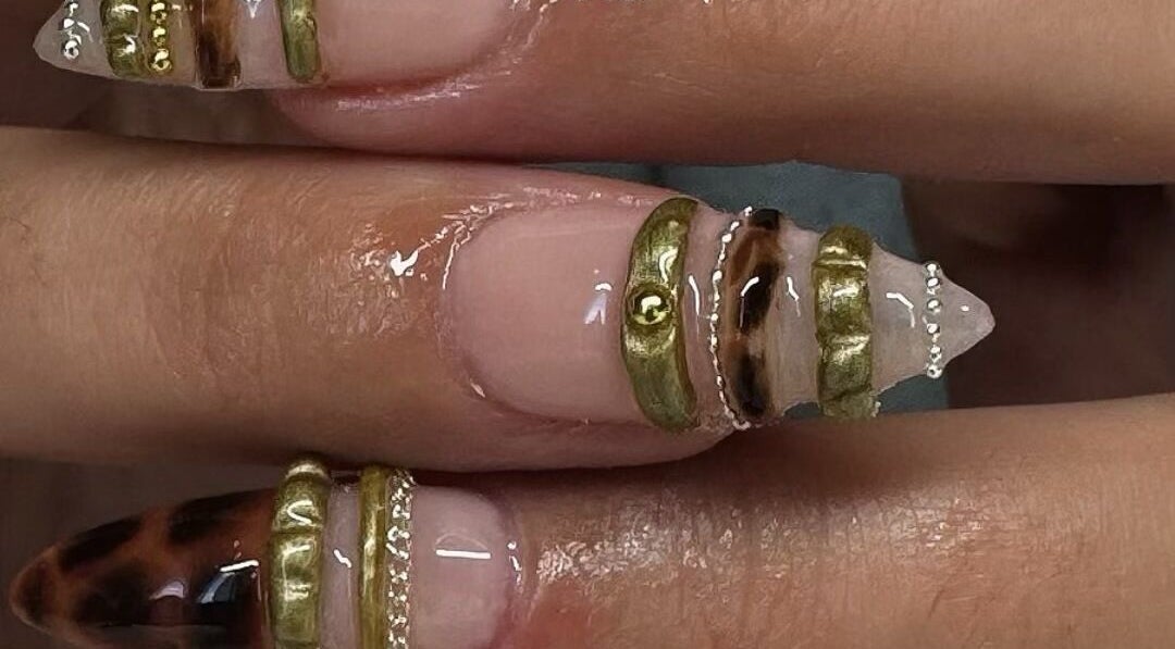 Elegant nail art with gold accents at Byhollie, Rochdale, England, GB, showcasing intricate design.