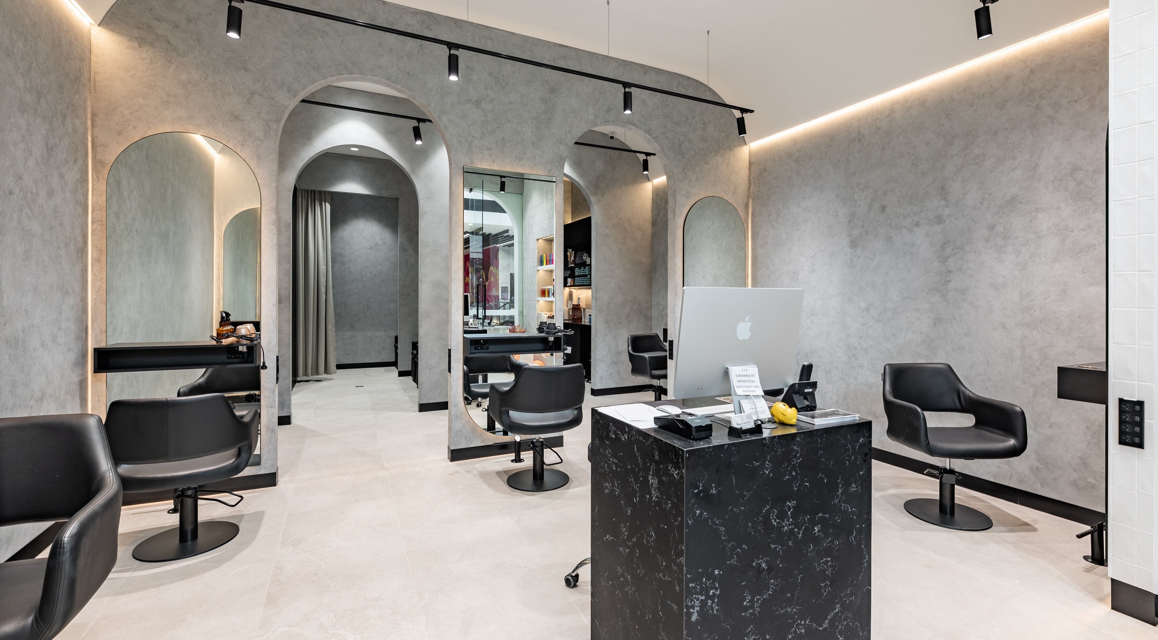 Sleek interior of Master Colour Hair, Oran Park, New South Wales, AU showcasing modern styling chairs and mirrors.
