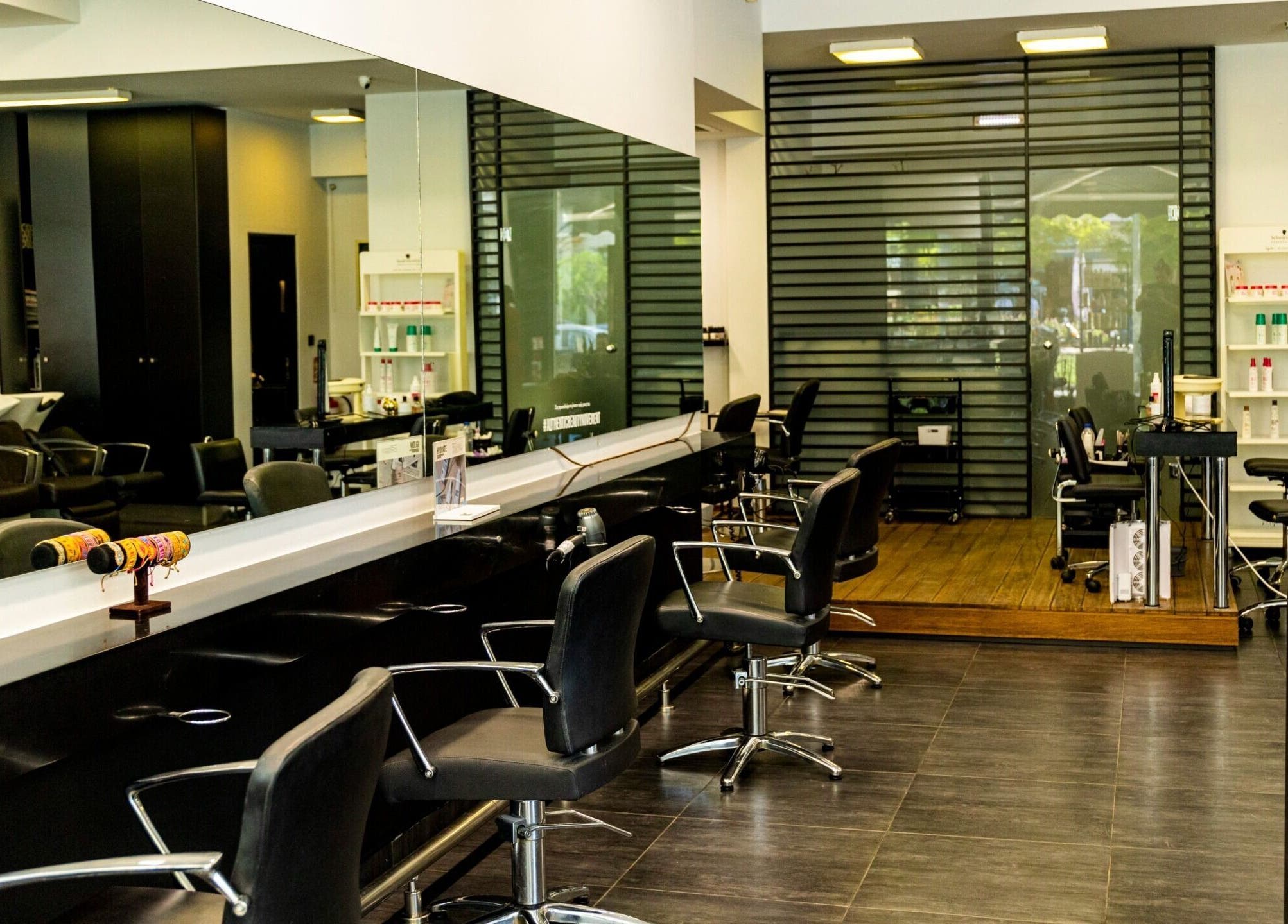 Εσωτερικός χώρος του Face to Face, κομμωτήριο στην Νέα Σμύρνη GR με καρέκλες και καθρέφτες.