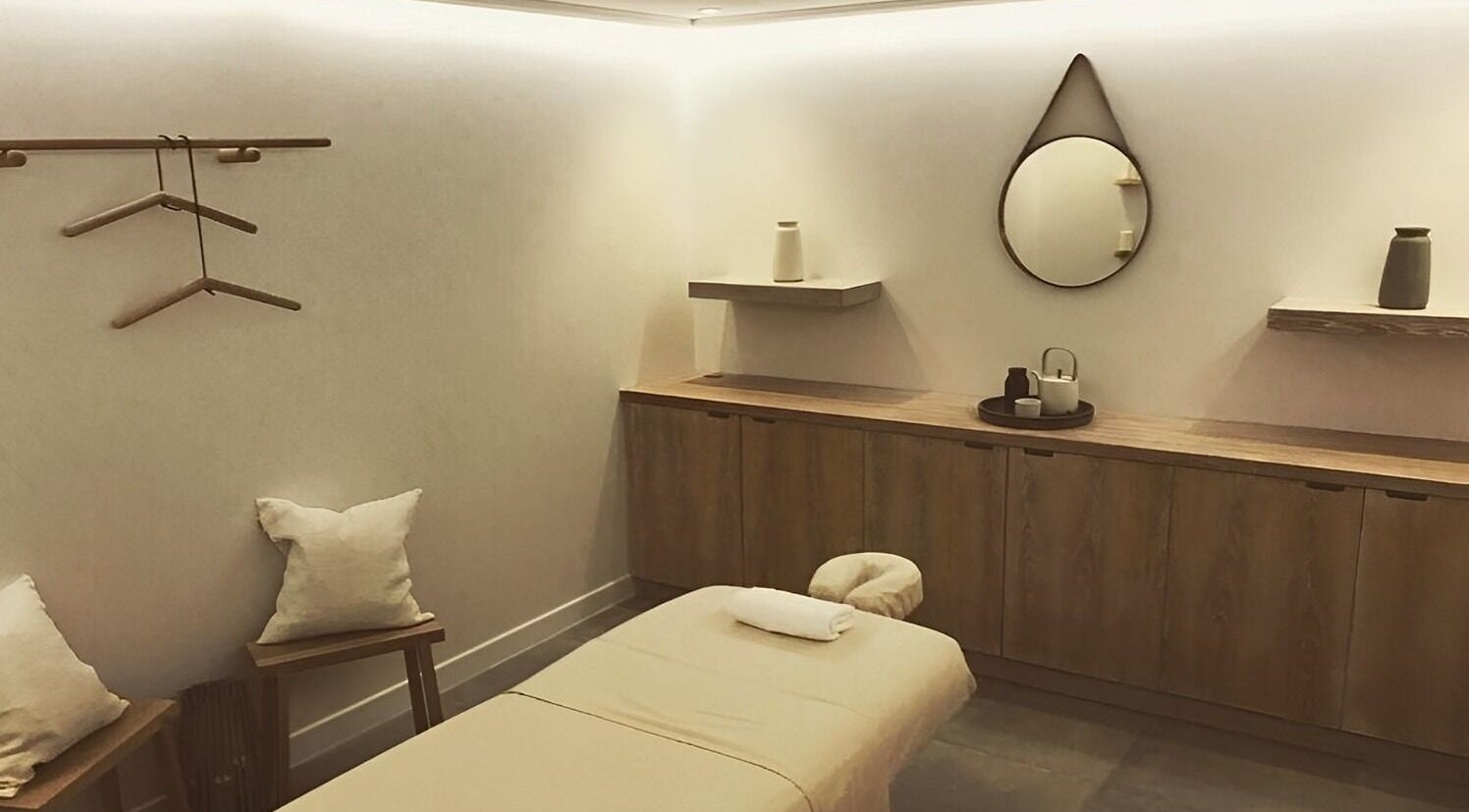 Elegant spa room at The Method, Edinburgh, Scotland, GB, featuring a massage table and soothing decor.