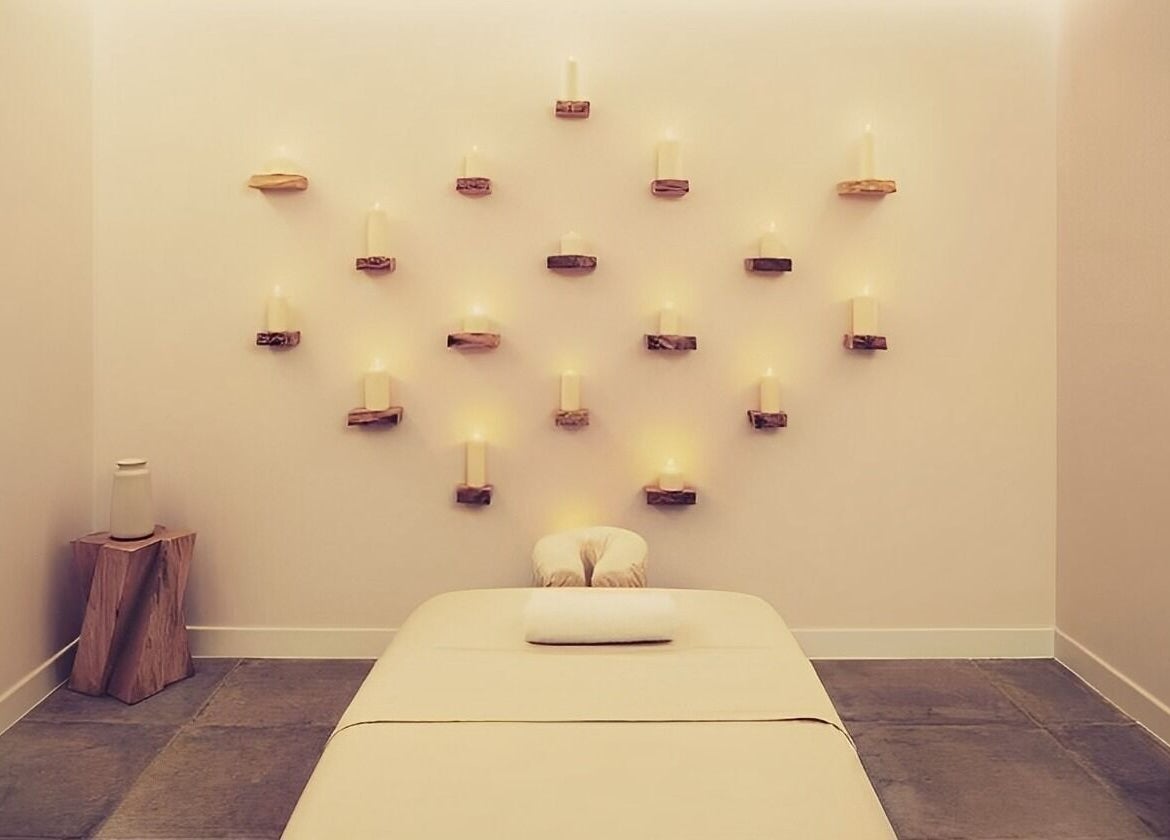 Tranquil massage room with candles at The Method, Edinburgh, Scotland, GB, enhancing relaxation and wellness.