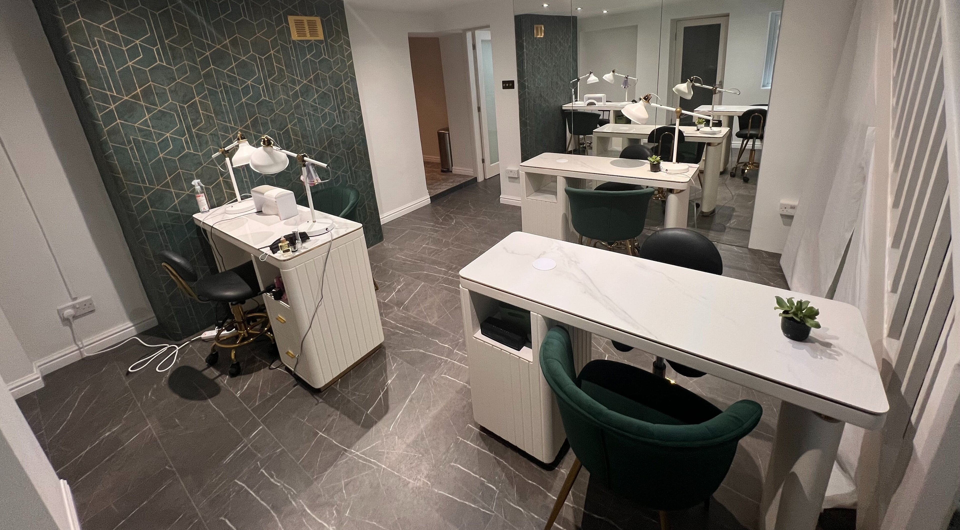 Stylish nail station at Beauty House 73, London, England, GB with green chairs and elegant decor.