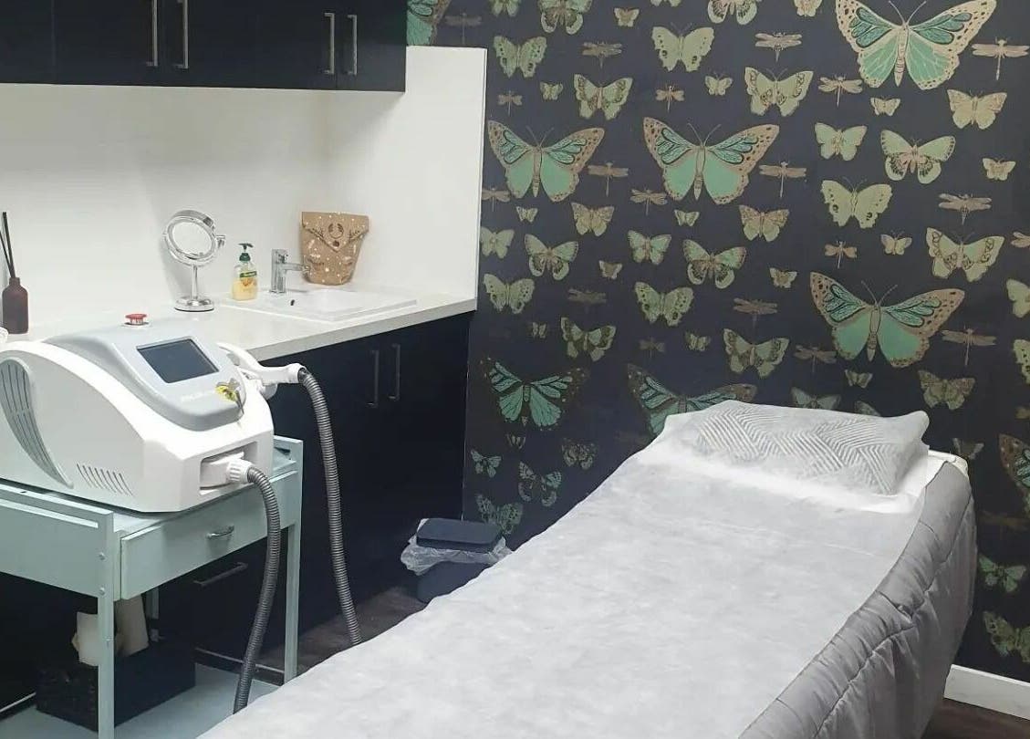 INKredible Beauty N Laser treatment room in Melbourne, Victoria, AU with butterfly-themed decor and laser equipment.