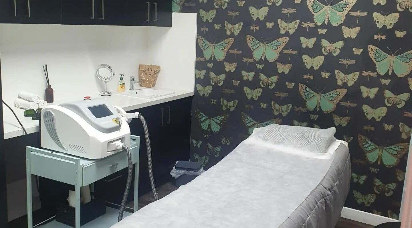 INKredible Beauty N Laser treatment room in Melbourne, Victoria, AU with butterfly-themed decor and laser equipment.