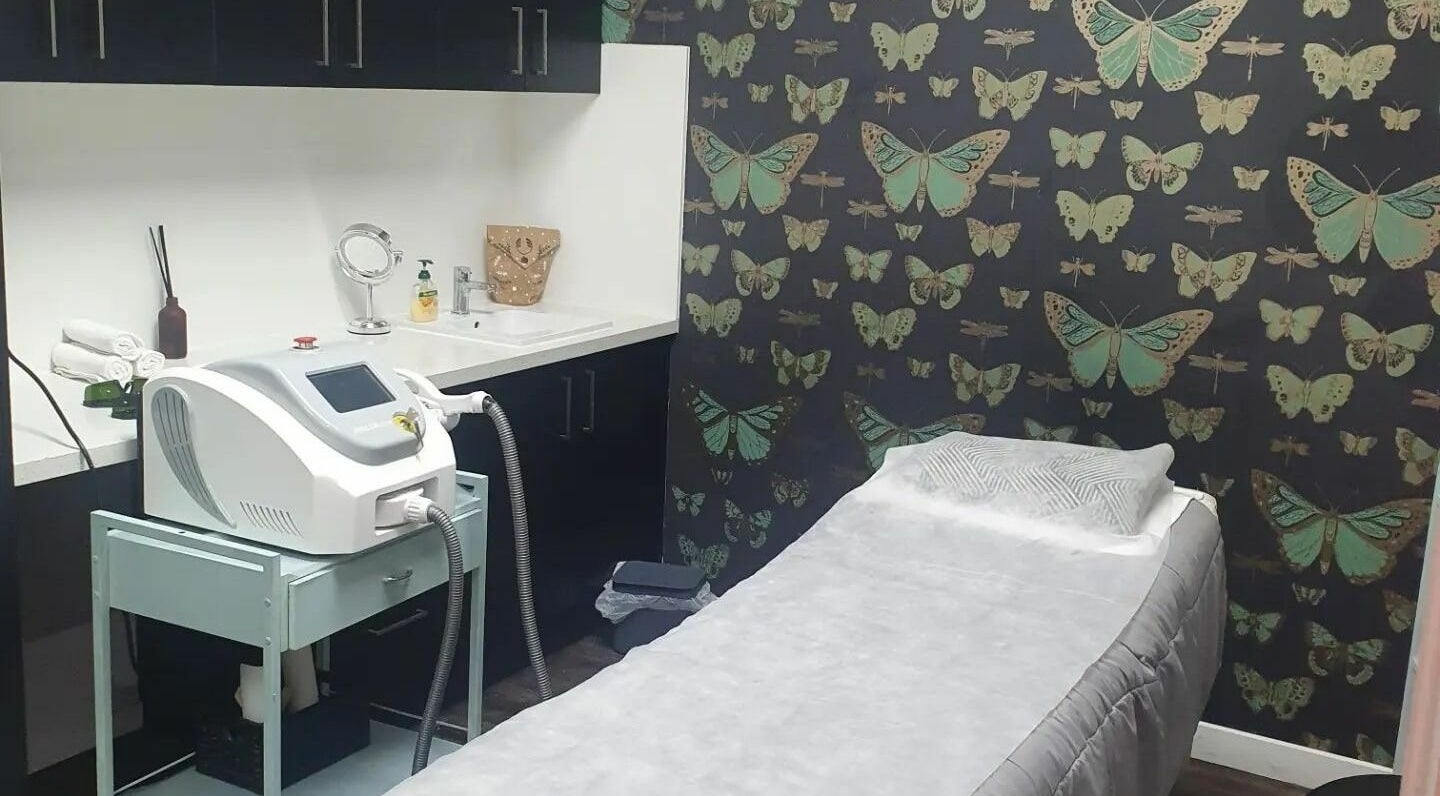 INKredible Beauty N Laser treatment room in Melbourne, Victoria, AU with butterfly-themed decor and laser equipment.