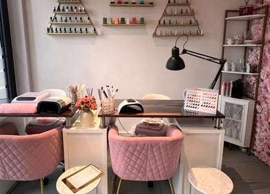 Espace manucure élégant chez G Beauty Geneve, Vernier, Genève, CH, avec murs floraux et fauteuils roses.