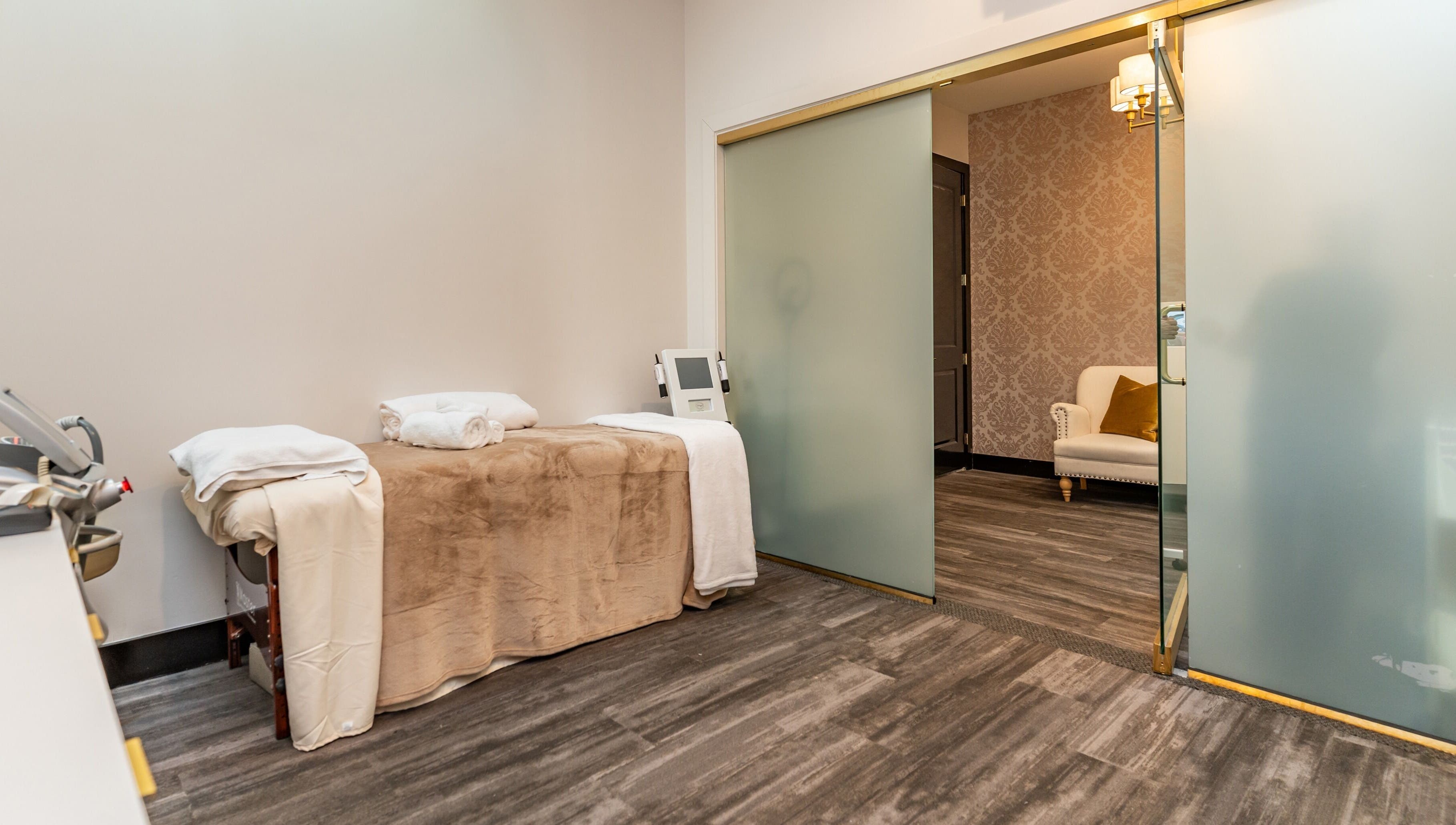 Tranquil treatment room at NU Laser Spa, Great Neck Plaza, New York, US, featuring cozy massage table.
