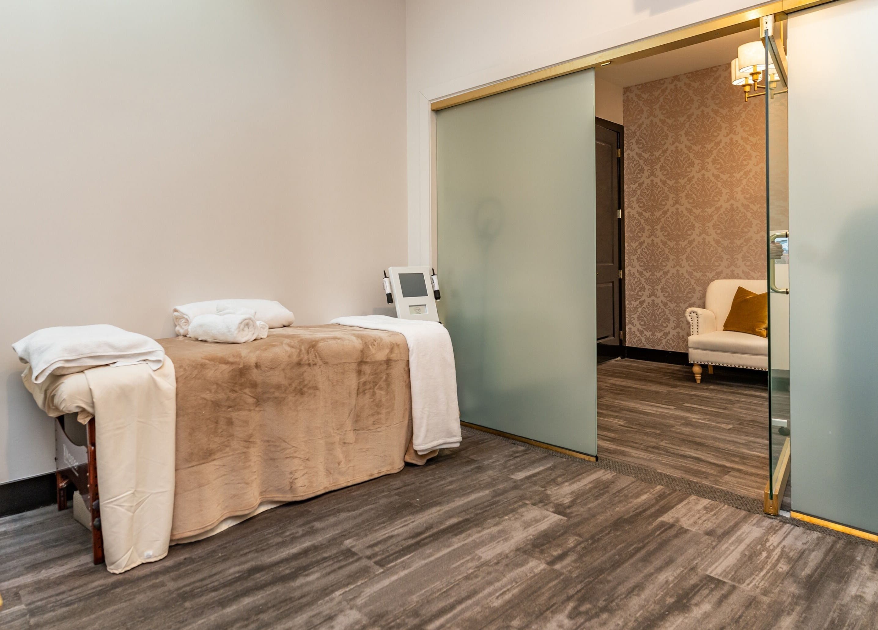 Tranquil treatment room at NU Laser Spa, Great Neck Plaza, New York, US, featuring cozy massage table.