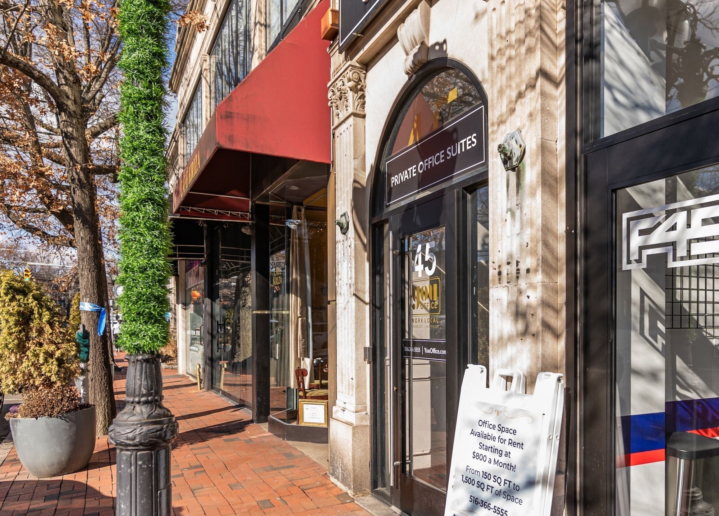 Street view of NU Laser Spa at Great Neck Plaza, New York, US showcasing elegant storefronts.