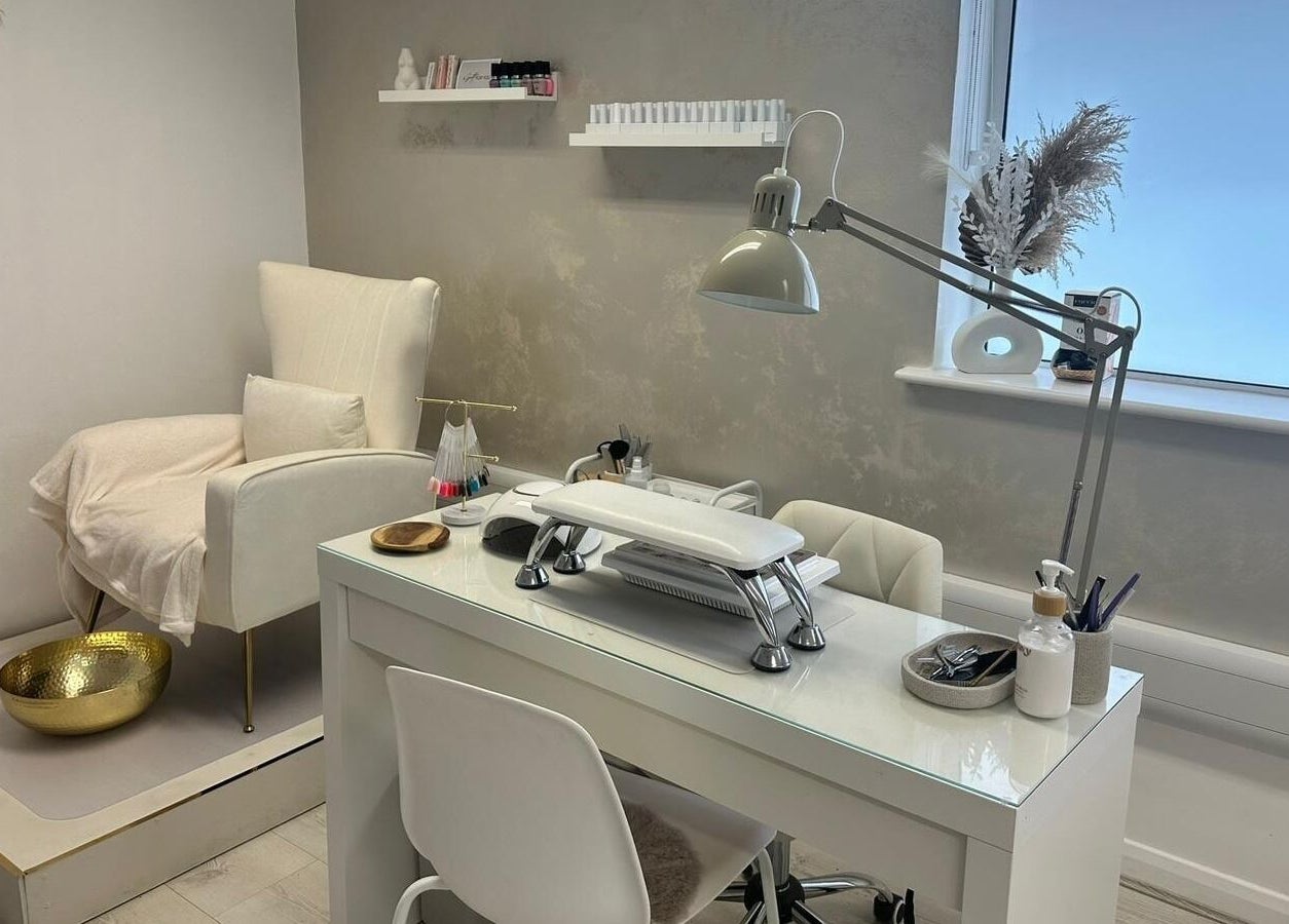 Chic nail station at JM Aesthetically Yours, Hilton, England, GB, featuring a cozy chair and manicure desk.