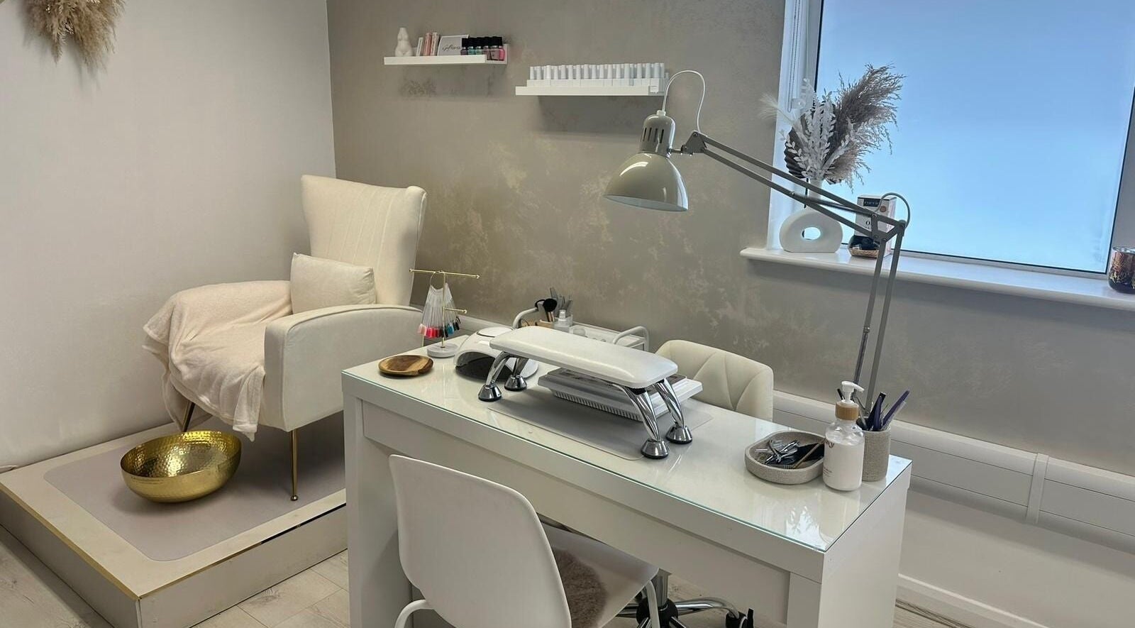 Chic nail station at JM Aesthetically Yours, Hilton, England, GB, featuring a cozy chair and manicure desk.