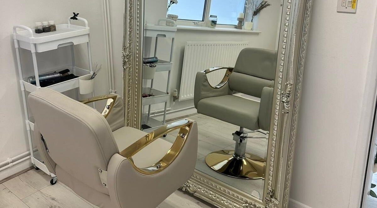 Elegant salon chair and ornate mirror at JM Aesthetically Yours, Hilton, England, GB.