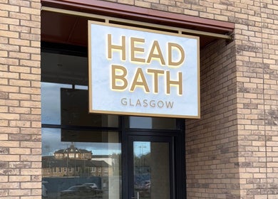 Entrance sign of Head Bath Glasgow, beauty venue in Glasgow, Scotland, GB with brick exterior.
