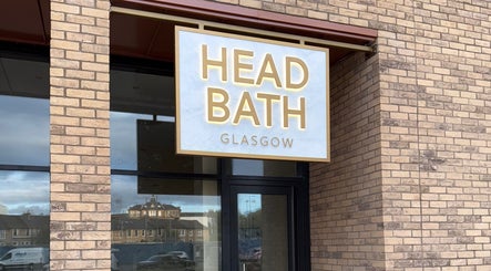 Entrance sign of Head Bath Glasgow, beauty venue in Glasgow, Scotland, GB with brick exterior.