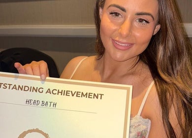 A person holding an outstanding achievement award for Head Bath Glasgow, Scotland, GB.