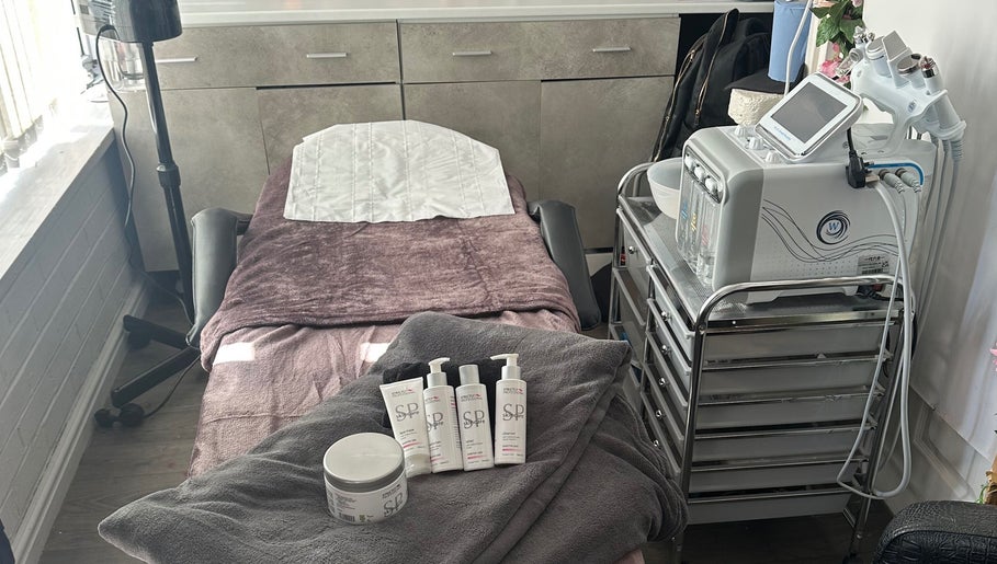 Relaxing treatment room at Divine Hair and Aesthetics in Middlesbrough, England with skincare products and equipment.