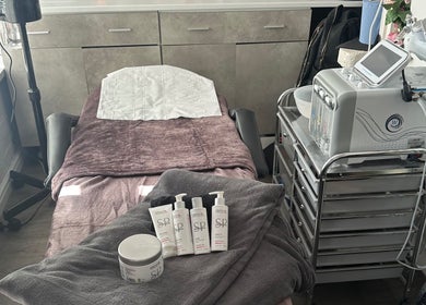 Relaxing treatment room at Divine Hair and Aesthetics in Middlesbrough, England with skincare products and equipment.