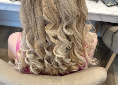 Blonde hair styled in beautiful curls at Divine Hair and Aesthetics in Middlesbrough, England, GB.