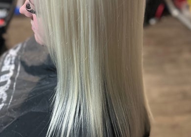 Sleek and glossy blonde hair styling at Divine Hair and Aesthetics in Middlesbrough, England, GB.