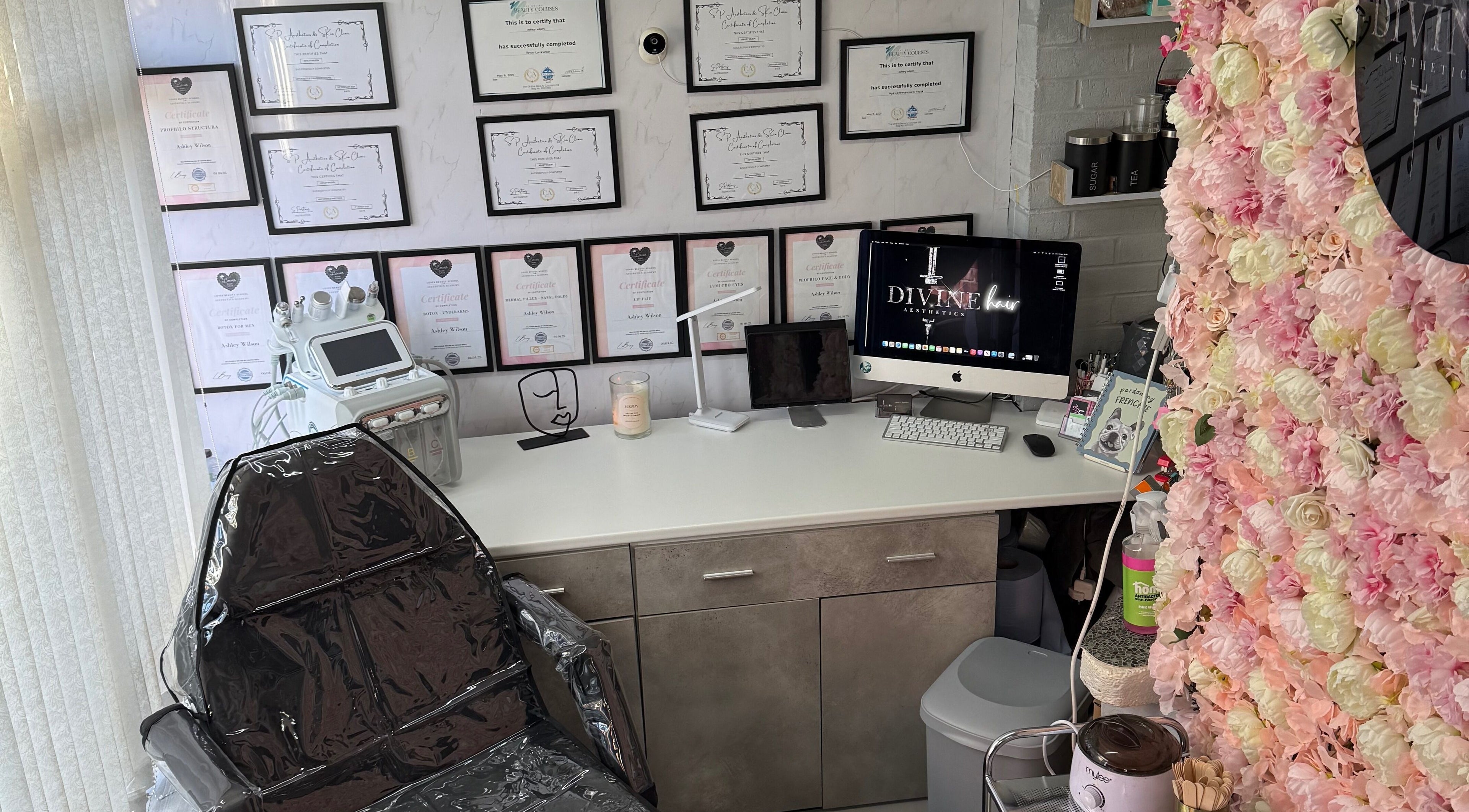 Interior of Divine Hair and Aesthetics in Middlesbrough, England, GB, showcasing flower decor and a treatment chair.