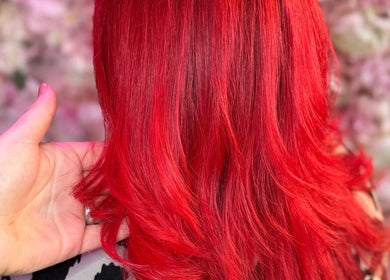 Vibrant red hair styled elegantly at Divine Hair and Aesthetics, Middlesbrough, England, GB.