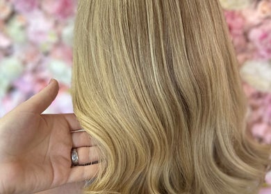 Elegant blonde hairstyle at Divine Hair and Aesthetics in Middlesbrough, England, GB. Showcasing smooth golden waves.