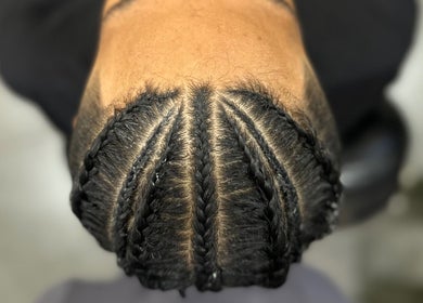 Intricate cornrows hairstyle at Syahrul Ilham, Riau Islands, Riau Islands, ID, showcasing expert braiding.