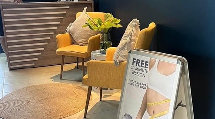 Inviting seating area at The Firm Durban North, Durban North, Kwazulu-natal, ZA with yellow chairs and a promo sign.
