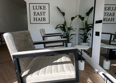 Modern salon chairs at Luke East Hair, Birmingham, England, GB highlighting stylish decor and comfort.