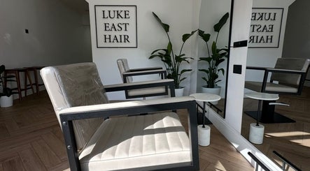 Modern salon chairs at Luke East Hair, Birmingham, England, GB highlighting stylish decor and comfort.