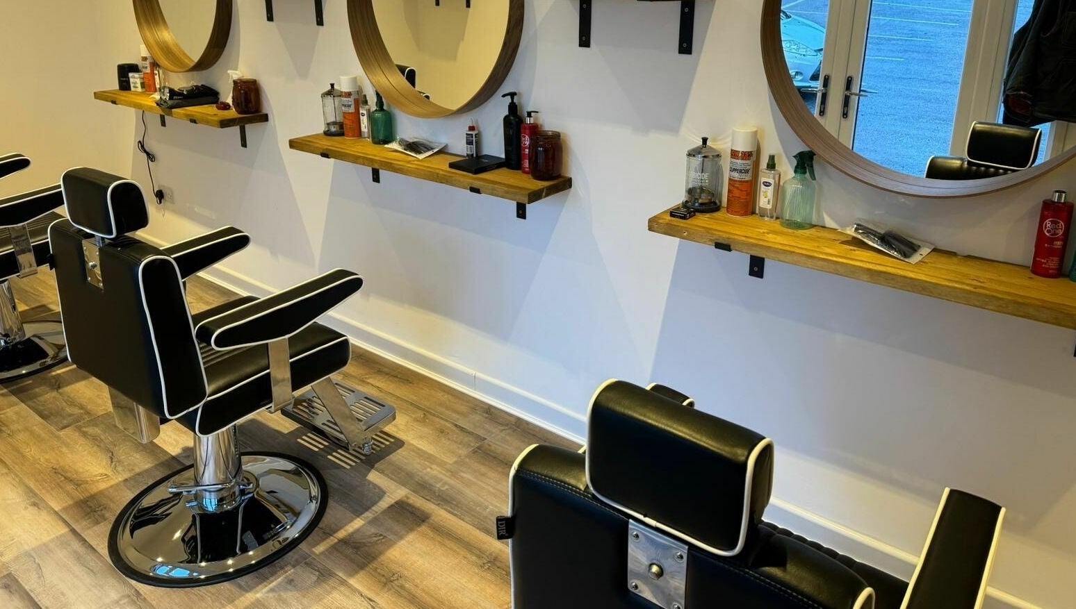 Stylish barber chairs and mirrors at Headspace Barbers in Walsall, England, GB, showcasing modern design.