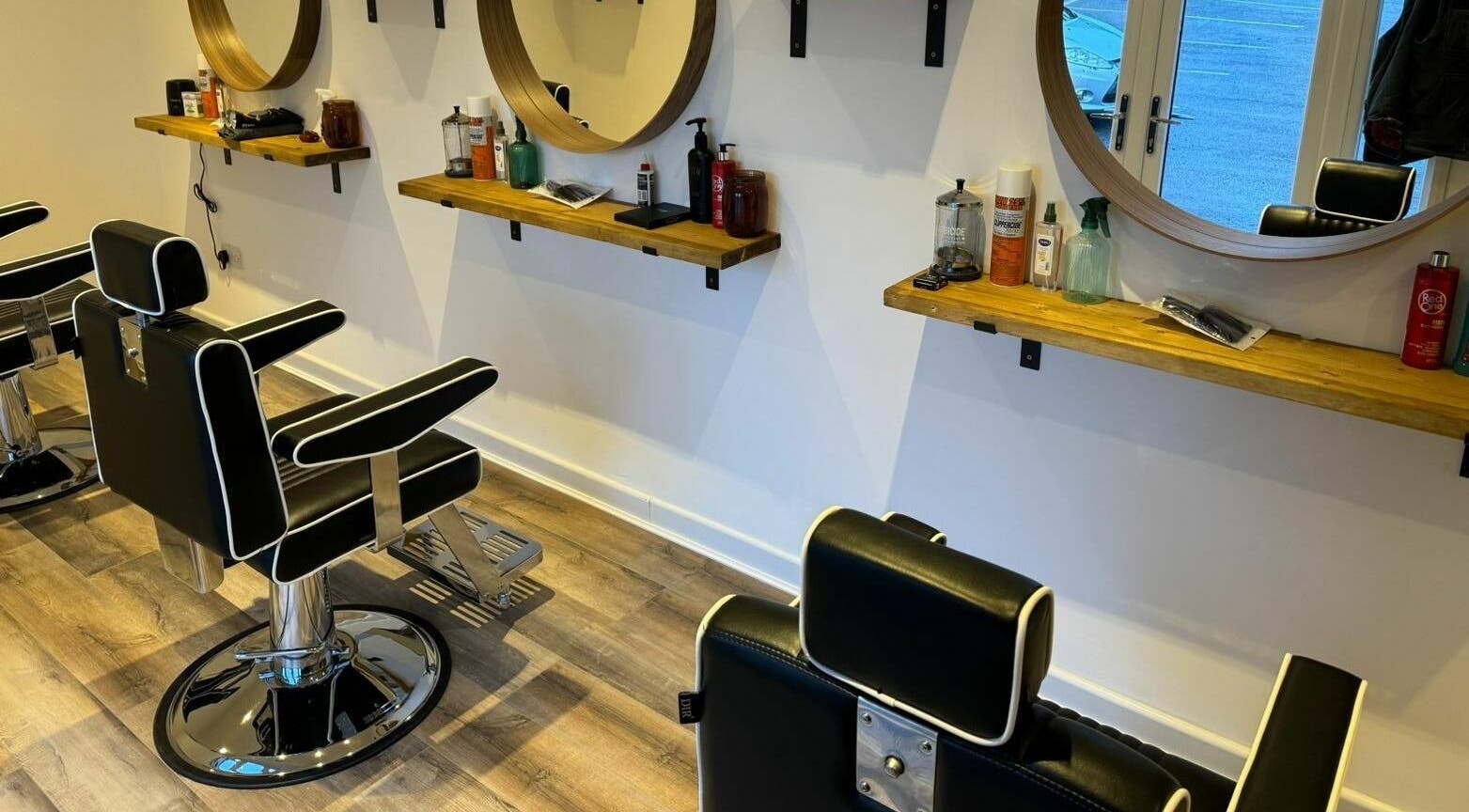 Stylish barber chairs and mirrors at Headspace Barbers in Walsall, England, GB, showcasing modern design.