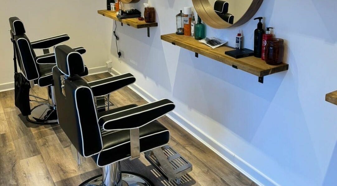 Modern barber chairs at Headspace Barbers, Walsall, England, GB. Sleek design with wooden shelves.