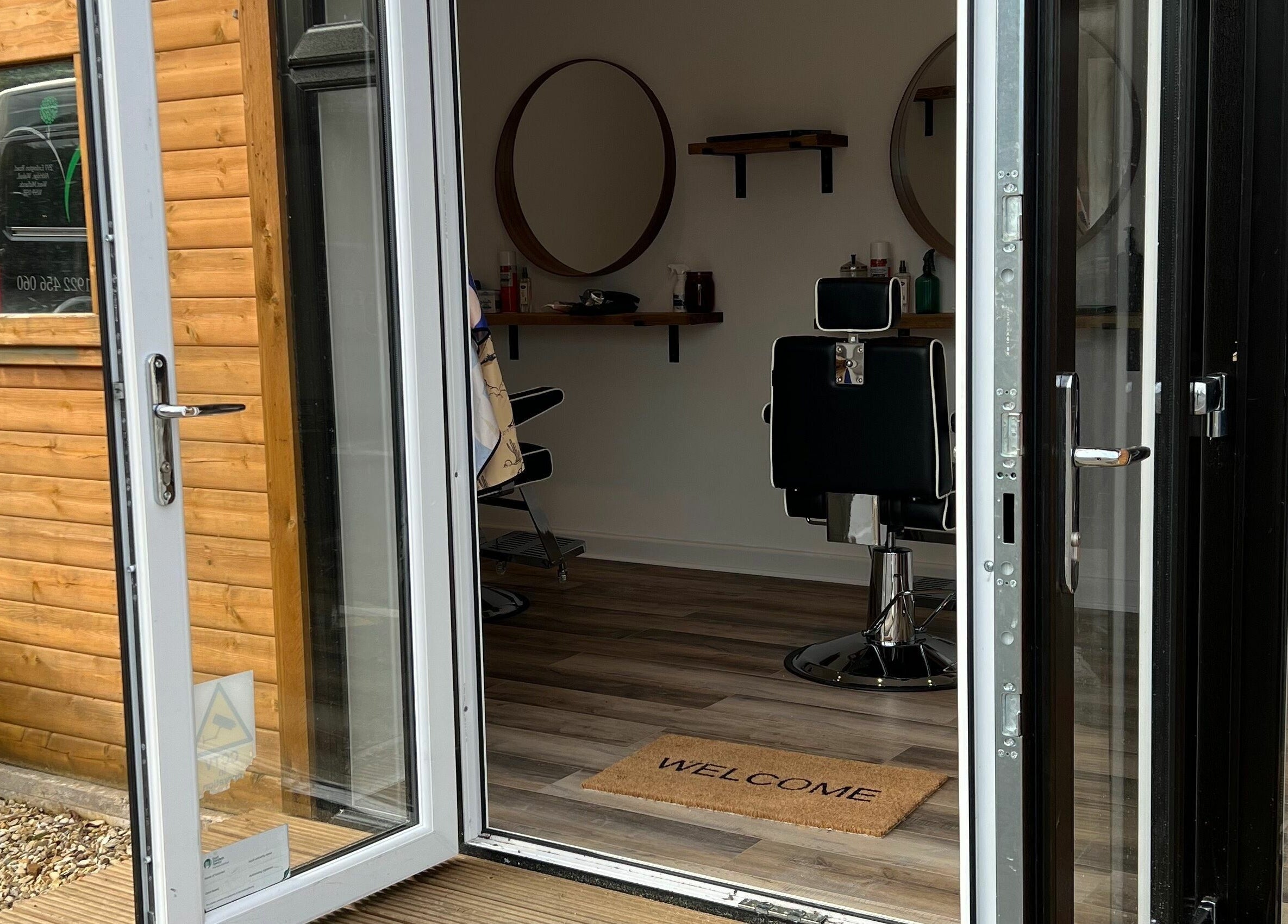 Open door at Headspace Barbers, Walsall, England, GB shows inviting interior with chairs and mirrors.