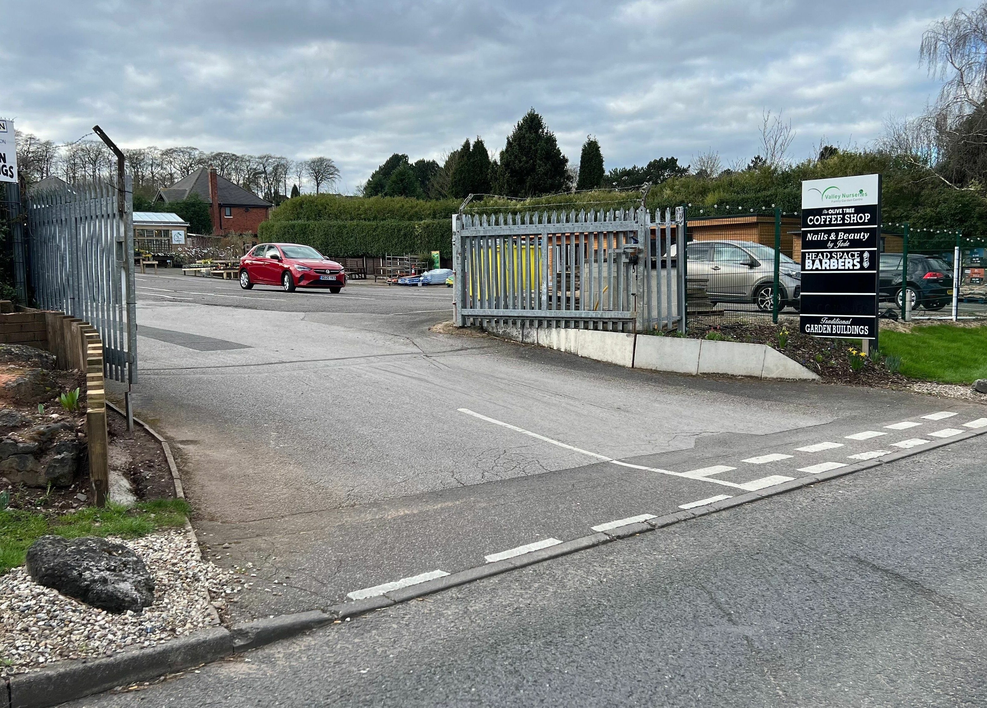 Entrance of Headspace Barbers, located in Walsall, England, with its welcoming driveway and surrounding greenery.