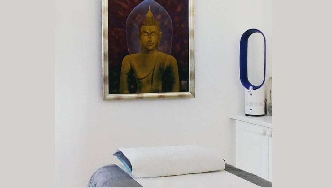 Relaxing massage room at Lt Holistics & Wellness, Lytham Saint Annes, England; peaceful Buddha art decor.