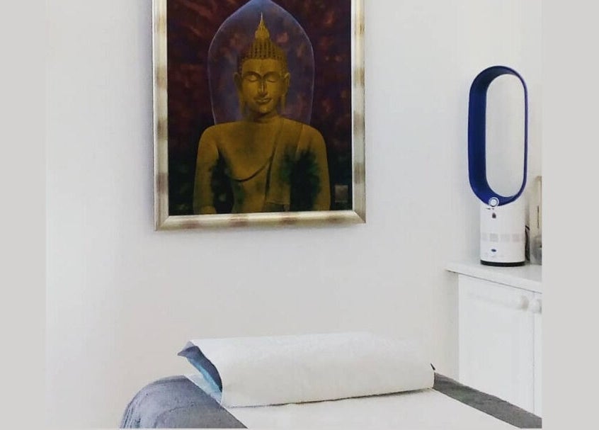 Relaxing massage room at Lt Holistics & Wellness, Lytham Saint Annes, England; peaceful Buddha art decor.