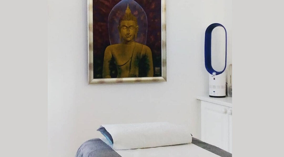 Relaxing massage room at Lt Holistics & Wellness, Lytham Saint Annes, England; peaceful Buddha art decor.