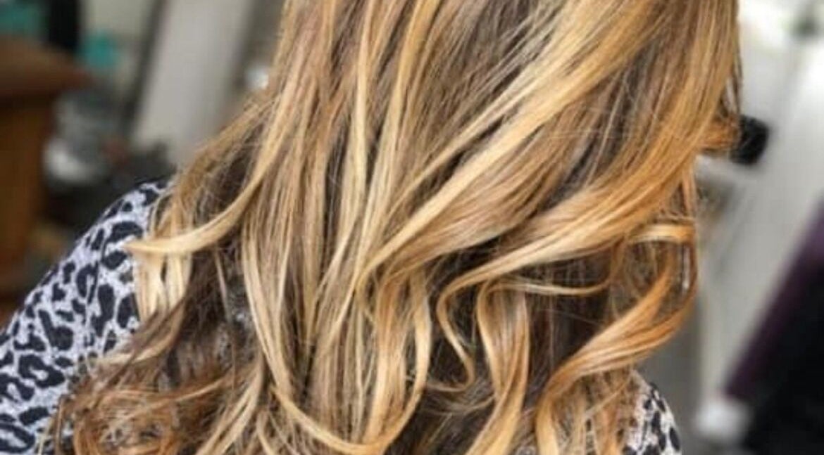 Blonde curls styled at ROK Hair Salon, Livingston, Scotland, GB, showcasing vibrant hair color artistry.