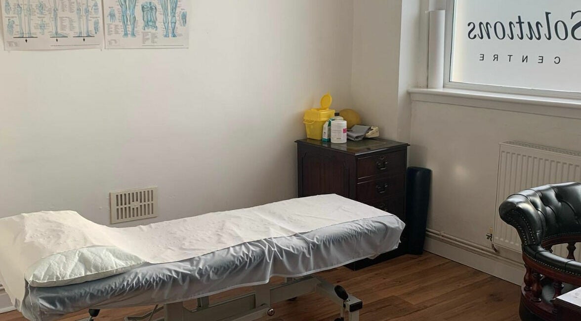 A tranquil treatment room at Swansea Health Solutions, Gowerton, Wales, GB, featuring a massage table.